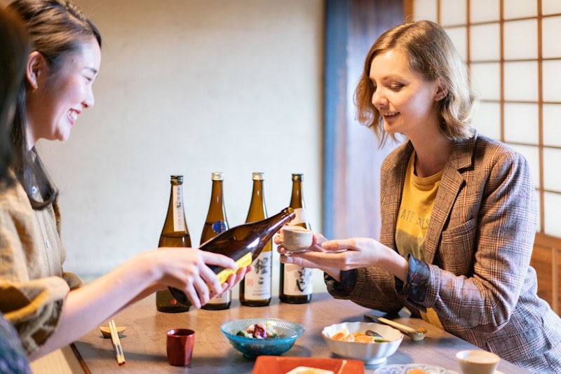 Foreign woman being served sake at a bar in Japan