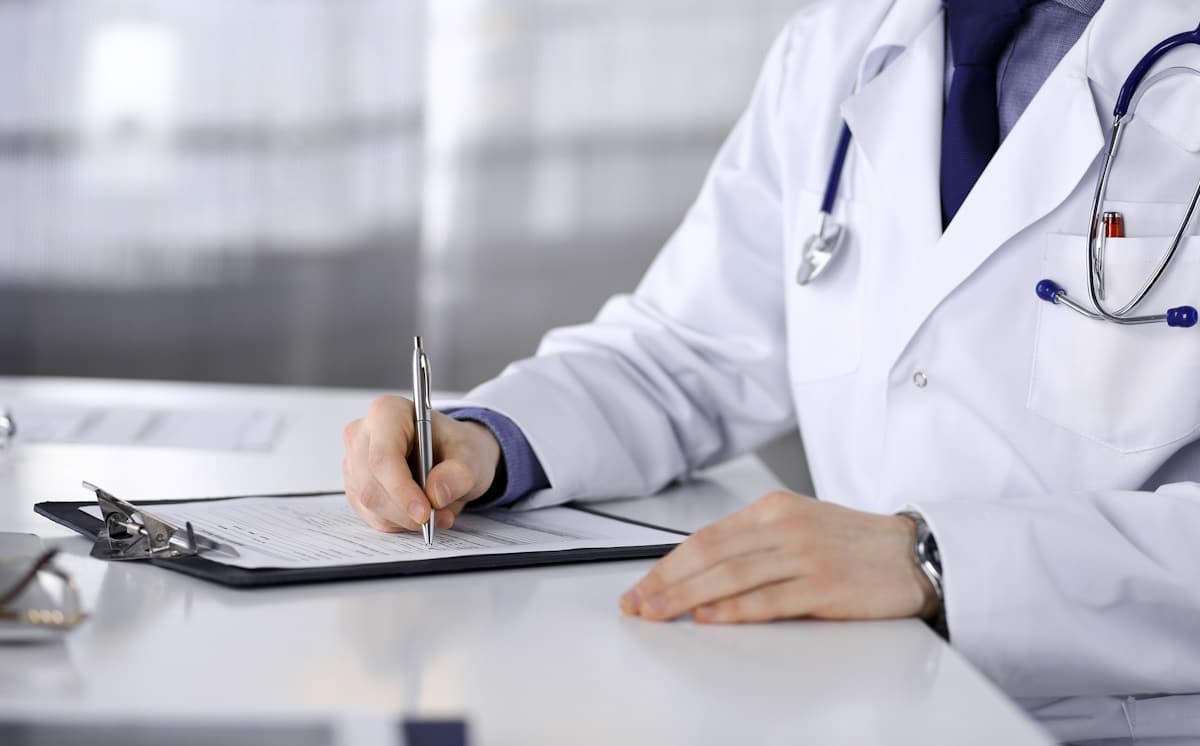 Doctor signing forms