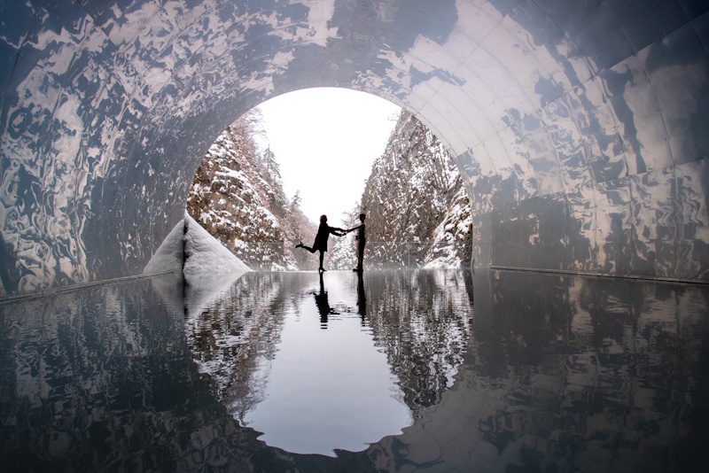 Tunnel of Light, Tokamachi, Niigata Prefecture - two people standing in silhouette at the end of a large polished tunnel