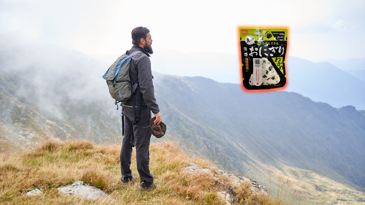 Hiker standing on cliff and looking at Onisi Onigiri