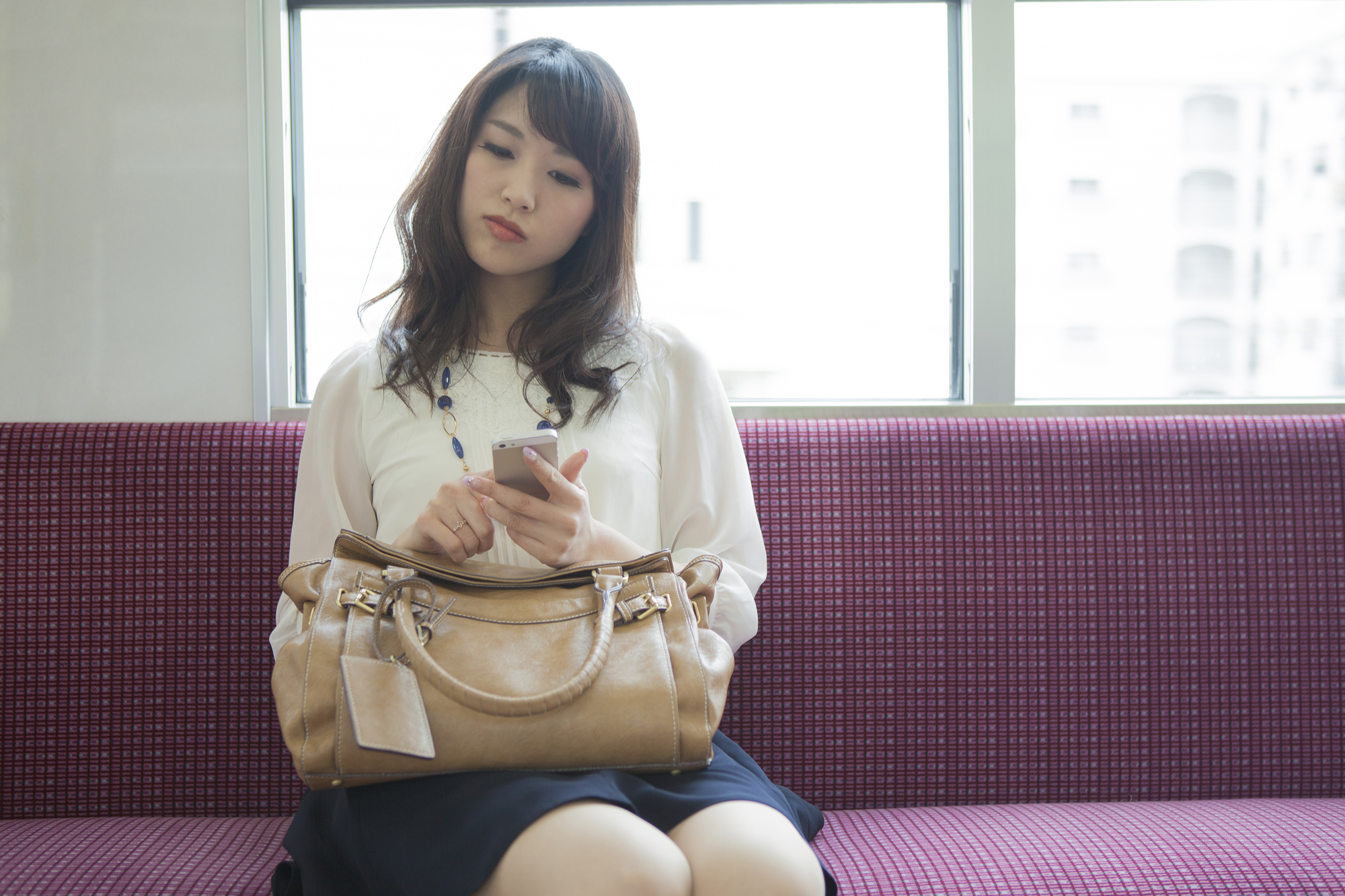 Woman using her smartphone on a train
