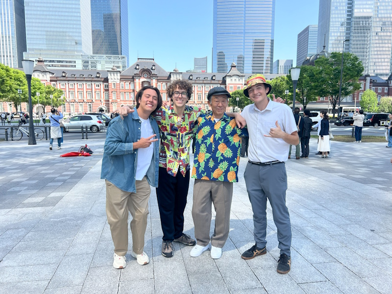 Picture of Tohru, third from left, weating a Hawaiian shirt (four men pictured total)