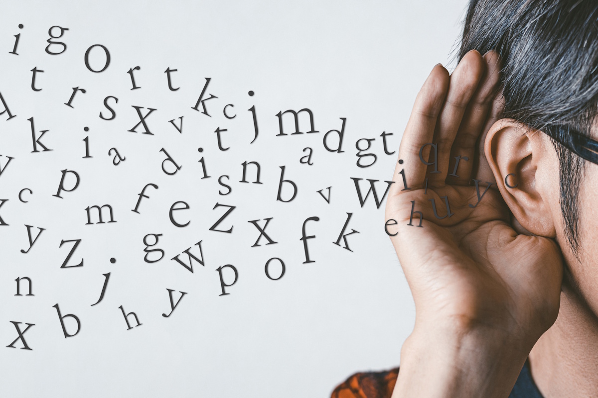 Man holding his hand up to his ear while an unintelligible stream of Latin characters enters it