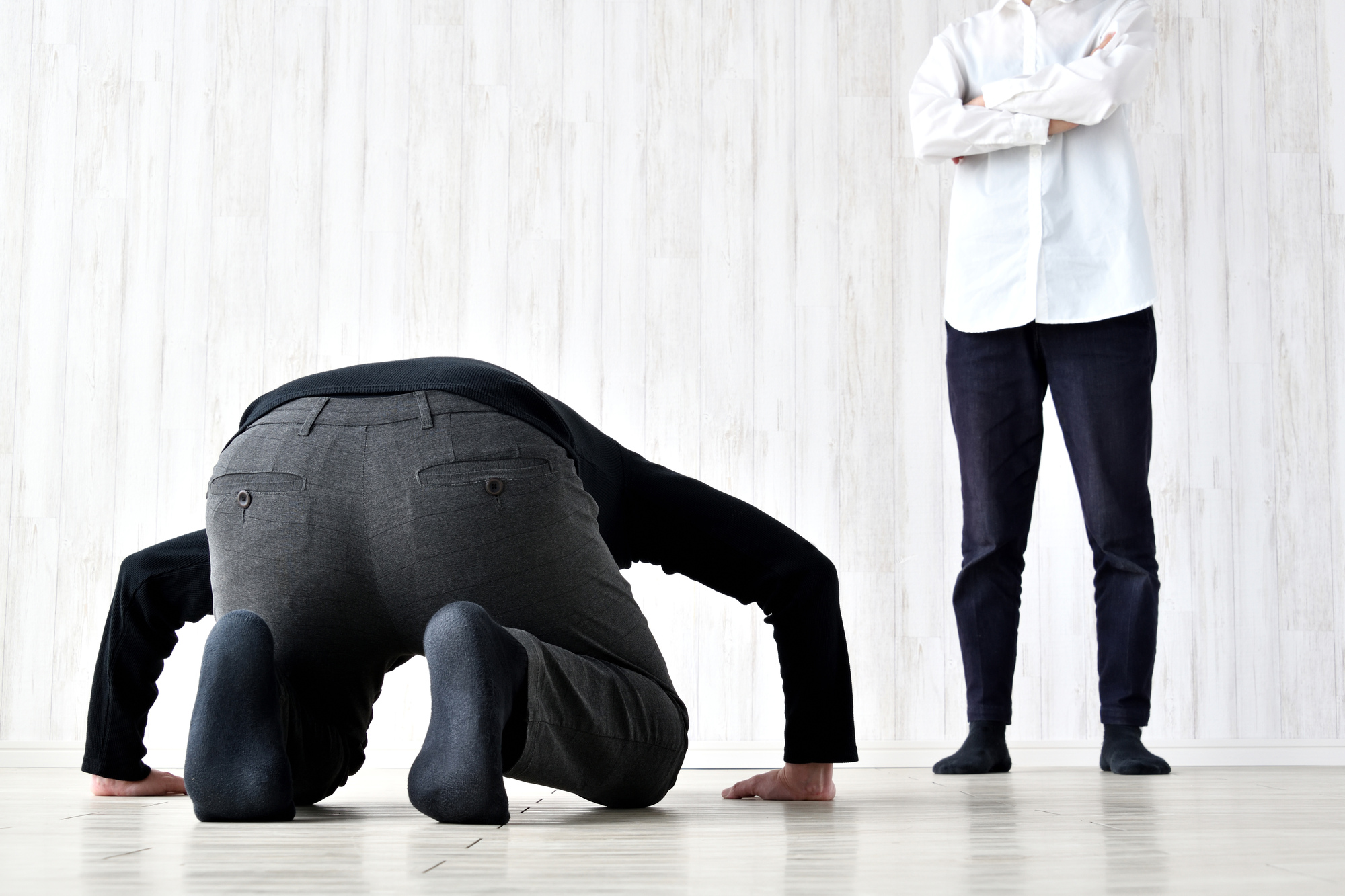 Man doing a deep apology dogeza bow to another man