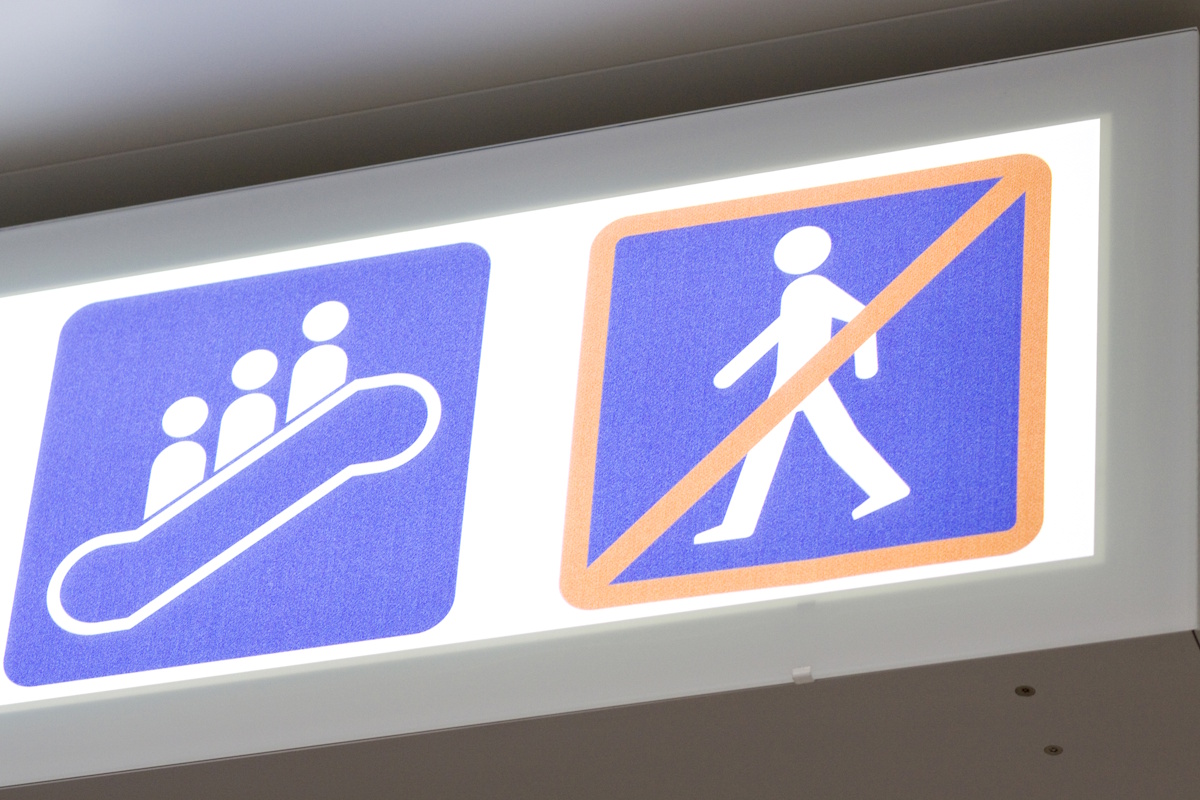 Sign showing standing on the escalator and prohibiting walking