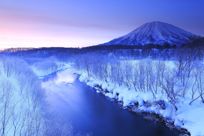 Mt. Yōtei in snow with everything covered in a blue haze