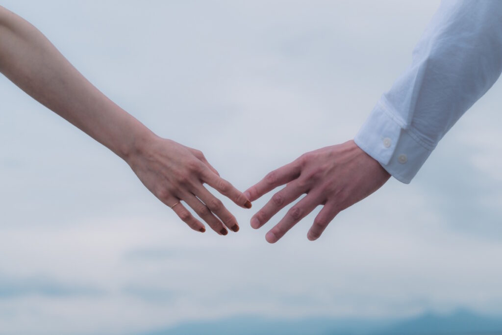 Picture of a man and a woman about to hold hands