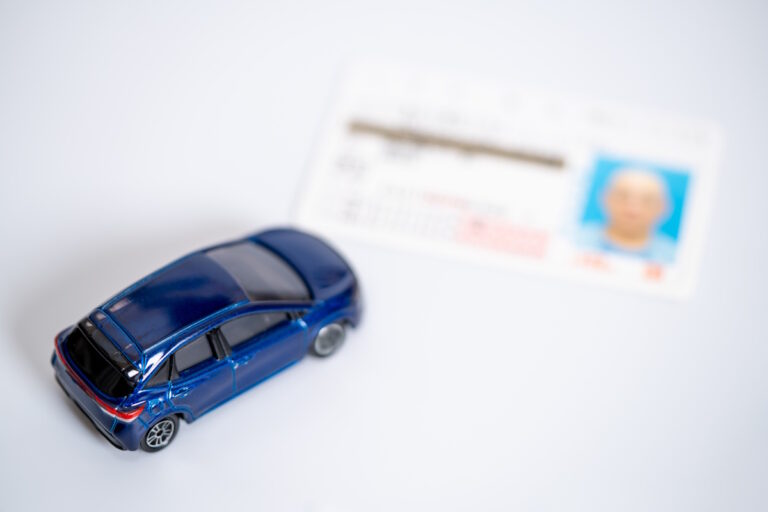 Picture of a toy car and a Japanese driver's license