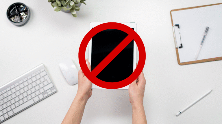 Picture of hands holding iPad with a banned symbol superimposed over the iPad