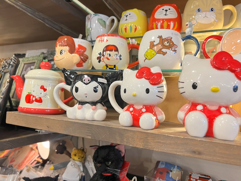 Pop culture memorabilia in Jin, Shimokitazawa. (Pictured: Various mugs showing Kuromi, Hello Kitty, Milky, and Jerry from Tom & Jerry)