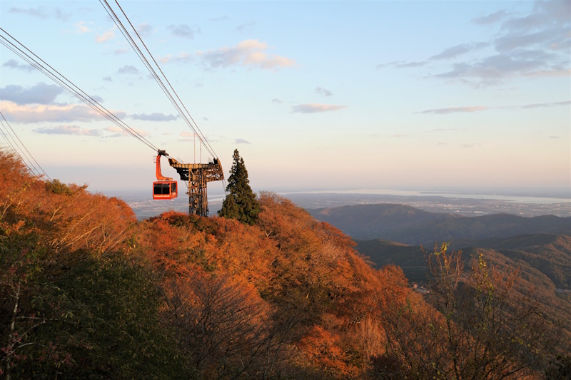 Mount Tsukuba Ropeway - red gondola against a background of autumn-colored mountains