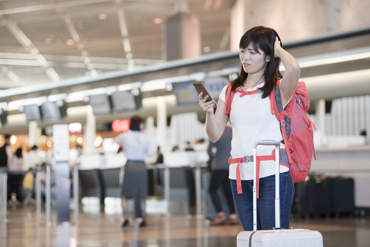 Woman looking confused and in trouble at an airport