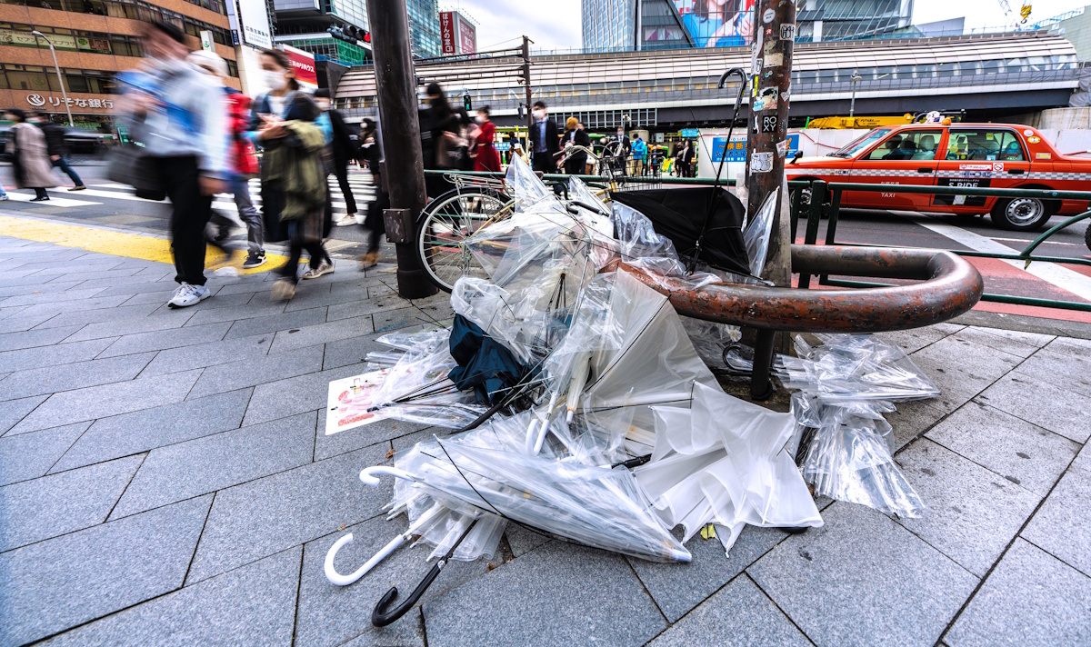 Discarded vinyl umbrellas piled up in Shibuya