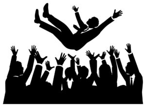 A businessman being tossed into the air by his colleagues