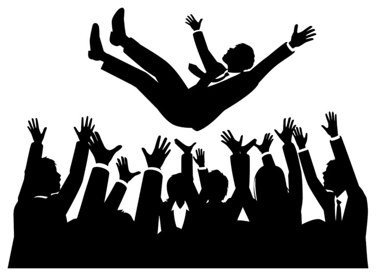 A businessman being tossed into the air by his colleagues