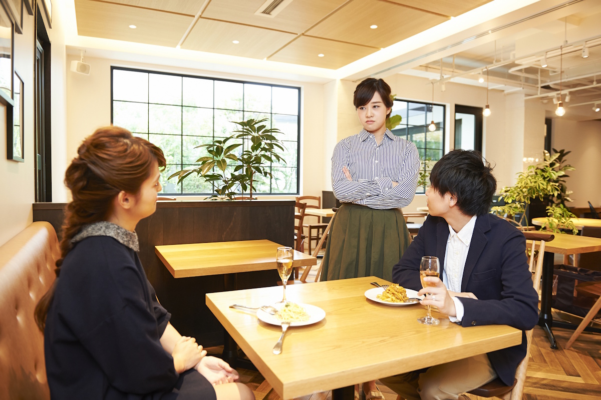 Wife staring down her husband's lover in a cafe