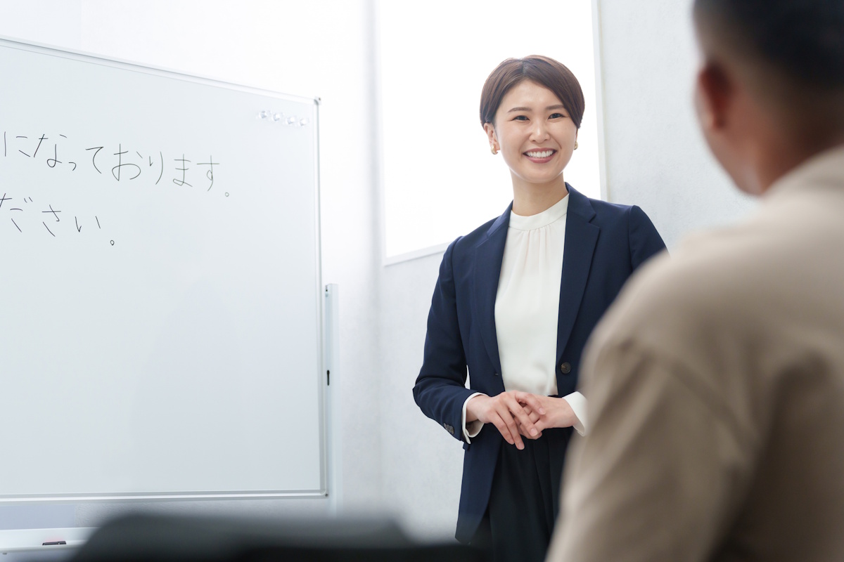 Photo of a woman teaching a man basic Japanese