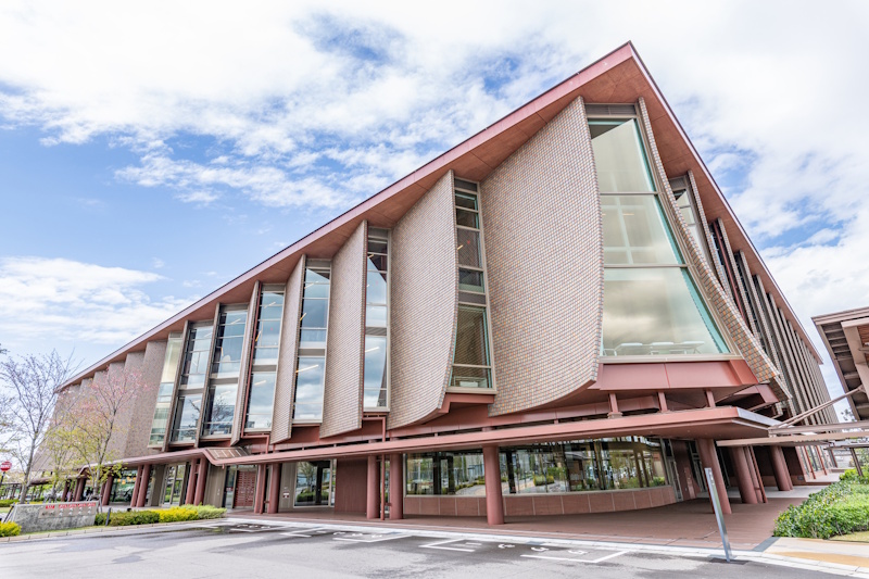 Exterior of the Ishikawa Prefectural Library in Kanazawa, with its distinctive sweeping brick-clad roof.