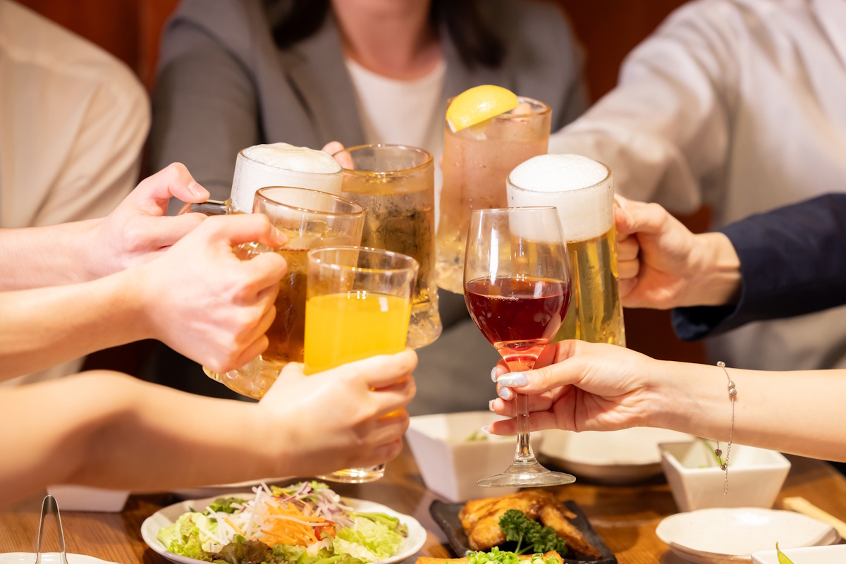 People clinking glasses together at an afte-work drink party