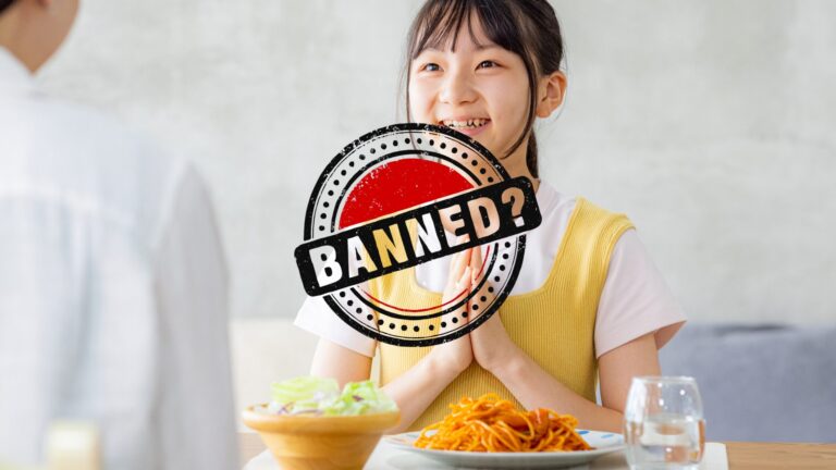 Girl holding her hands in the "itadakimasu" gesture with a "banned?" logo over her