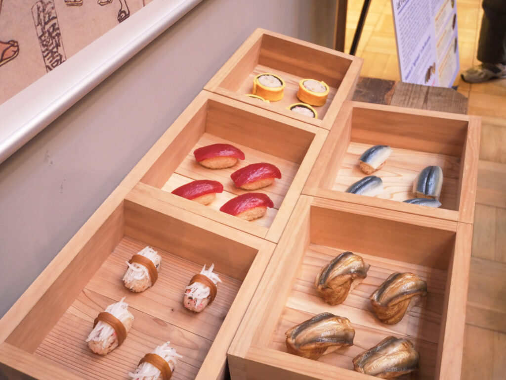 Plastic replicas of oversized Edo-period sushi in wooden boxes at the Fukagawa Edo Museum