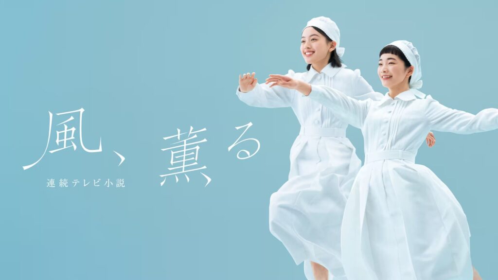 Promotional image for NHK's morning drama Kaze, Kaoru: two young women in white Meiji-era nursing uniforms and caps, smiling with arms outstretched against a pale-blue background, beside the Japanese title 風、薫る.