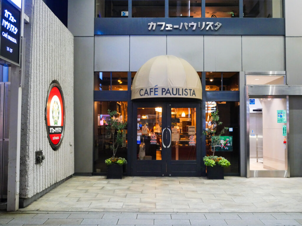 Street-level entrance of Café Paulista in Ginza, a domed awning reading CAFÉ PAULISTA over glass doors