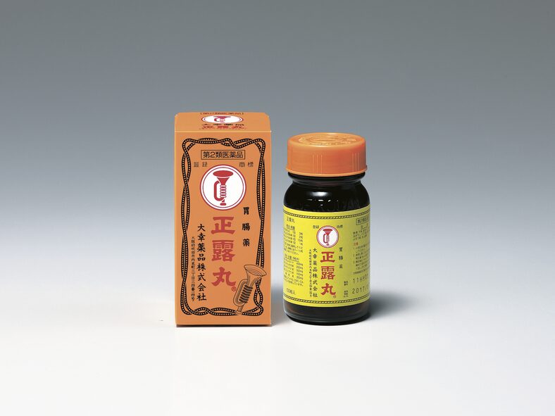 Box and bottle of Seirogan creosote stomach medicine with its trumpet logo