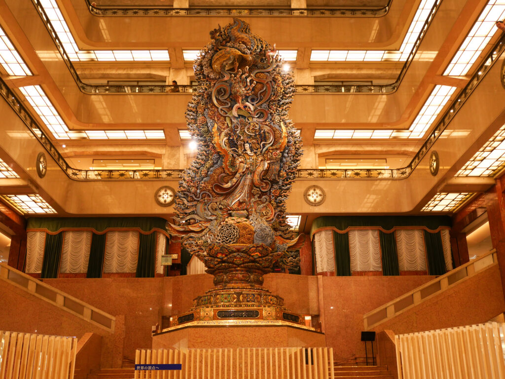 The full 11-meter Tennyo statue rising toward the skylight of Mitsukoshi Nihonbashi's central hall