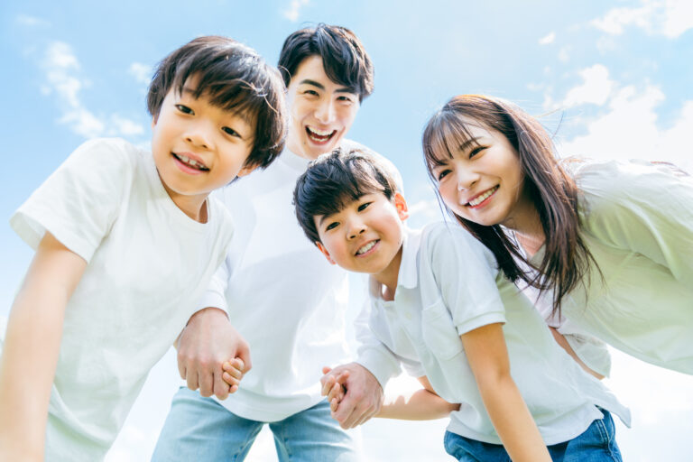 Japanese family of four looking at the camera