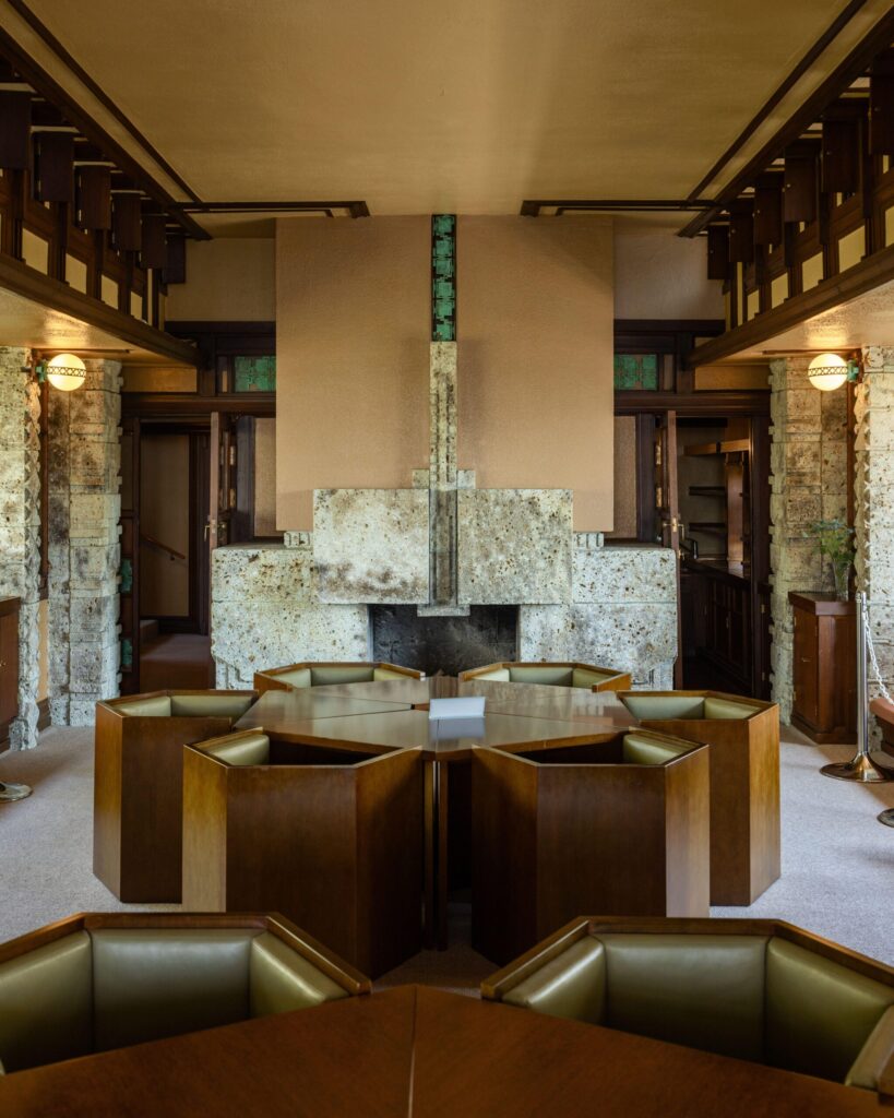 Inside the Yodoko Guest House: Frank Lloyd Wright's carved Oya-stone fireplace, green copper inlays, and built-in seating.
