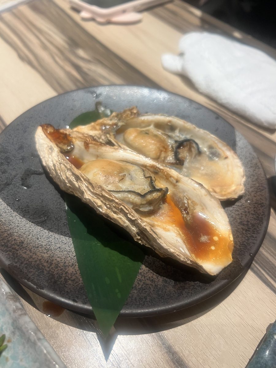 A grilled oyster served on the half shell