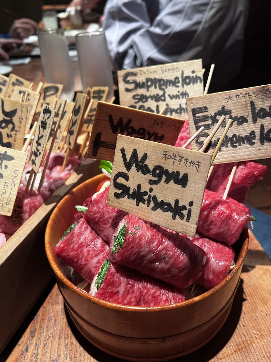 Wagyu sukiyaki skewers presented in a wooden box