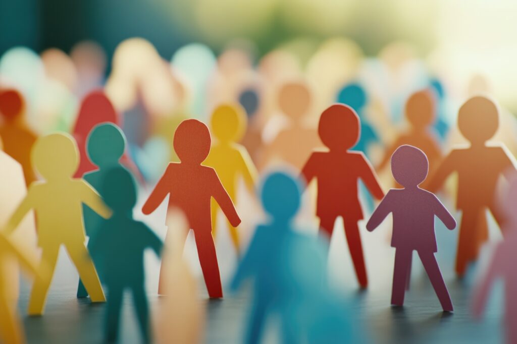Colorful paper cutout figures of people standing together, representing a diverse society