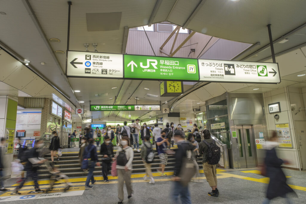 Commuters walk through the Waseda Entrance of JR Takadanobaba Station in Tokyo.