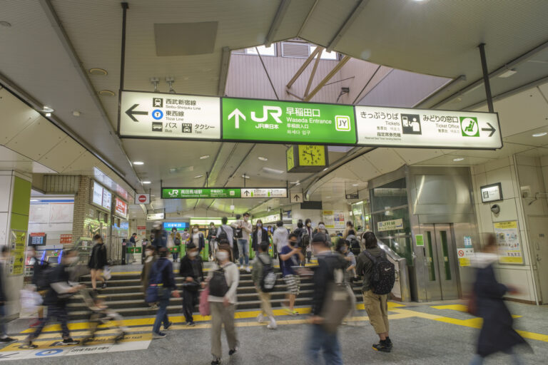 Commuters walk through the Waseda Entrance of JR Takadanobaba Station in Tokyo.