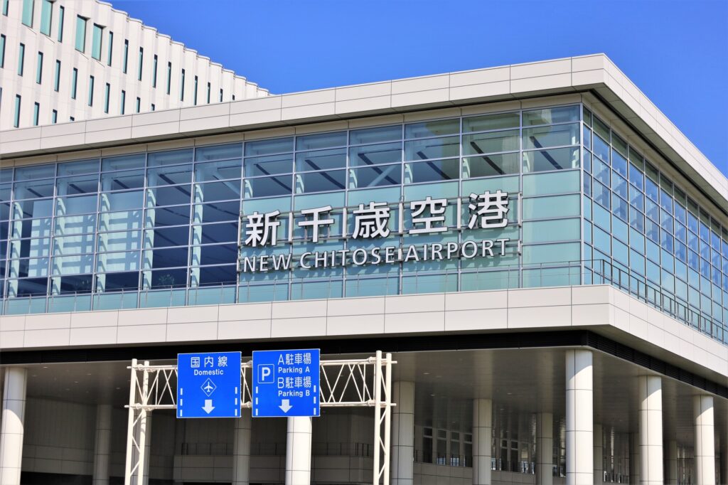 The glass facade of New Chitose Airport in Hokkaido, signed in Japanese and English