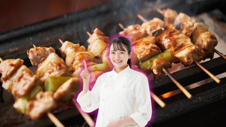 A woman in a white chef's jacket stands in front of chicken skewers grilling over charcoal.