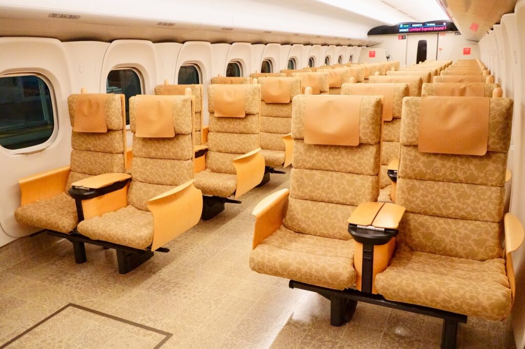 Rows of empty reserved seats inside a Shinkansen train car