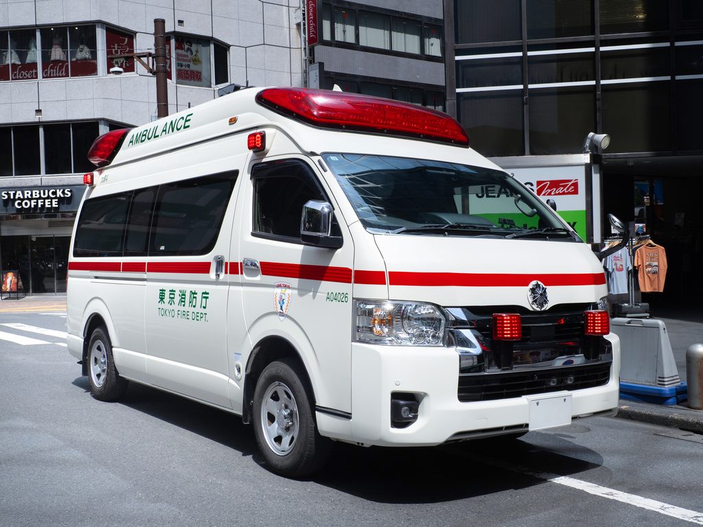 Tokyo Fire Department ambulance parked on a Tokyo street, marked "Ambulance" and 東京消防庁